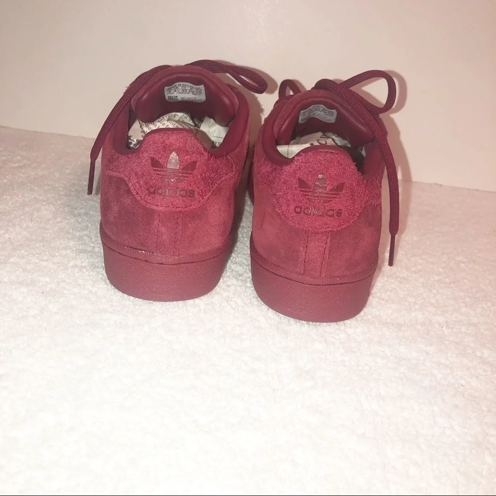 Adidas superstar suede burgundy shell toe sneaker.